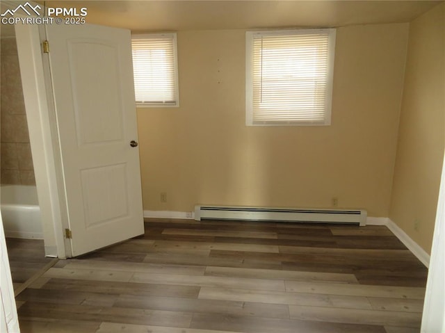 2354 E San Rafael St, Colorado Springs, CO 80909 - unfurnished room featuring wood finished floors, baseboard heating, and baseboards
