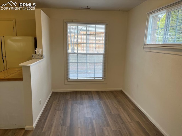 2354 E San Rafael St, Colorado Springs, CO 80909 - unfurnished dining area featuring wood finished floors and baseboards