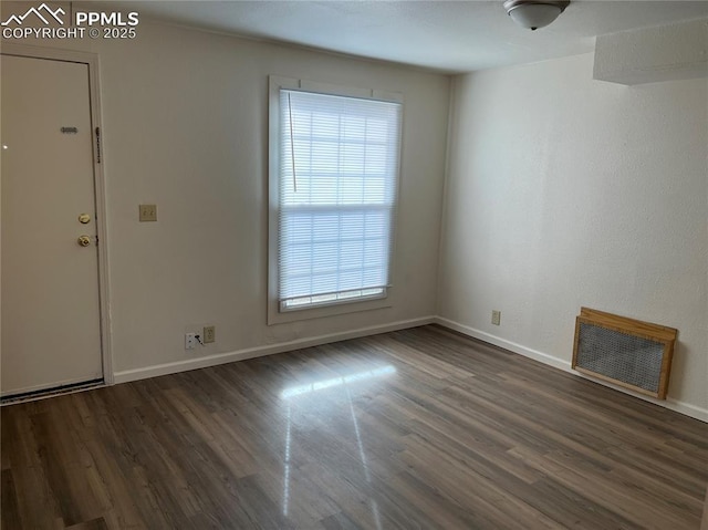 2354 E San Rafael St, Colorado Springs, CO 80909 - unfurnished living room featuring wood finished floors and baseboards