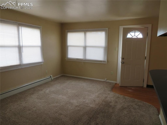 2354 E San Rafael St, Colorado Springs, CO 80909 - foyer with a baseboard heating unit, carpet flooring, and baseboards