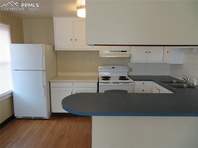 2354 E San Rafael St, Colorado Springs, CO 80909 - kitchen featuring white appliances, under cabinet range hood, a sink, white cabinetry, and wood finished floors