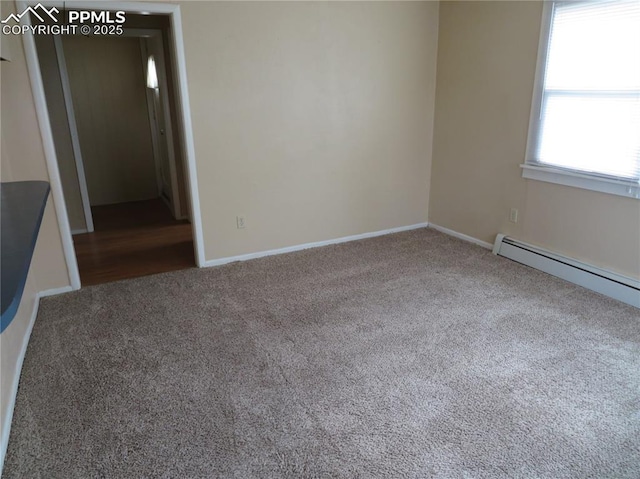 2354 E San Rafael St, Colorado Springs, CO 80909 - spare room featuring carpet floors, a baseboard heating unit, and baseboards