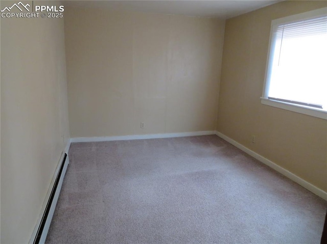 2354 E San Rafael St, Colorado Springs, CO 80909 - carpeted empty room featuring a baseboard heating unit and baseboards