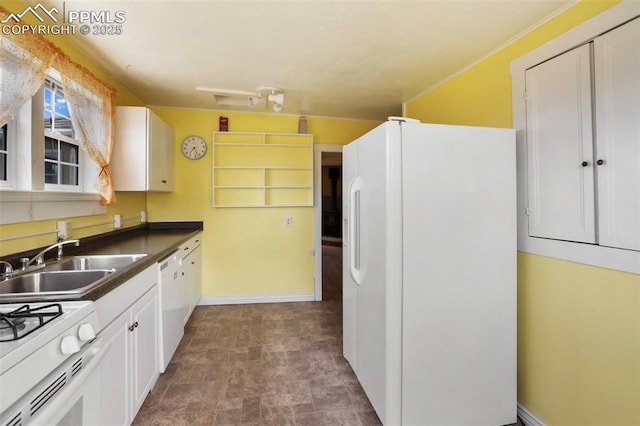 206 N 4th St, Victor, CO 80860 - kitchen with white appliances, a sink, stone finish floors, dark countertops, and white cabinetry