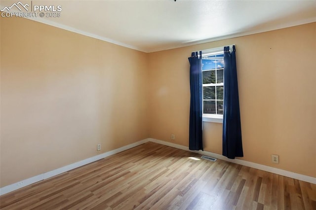 206 N 4th St, Victor, CO 80860 - empty room featuring wood finished floors, baseboards, and ornamental molding