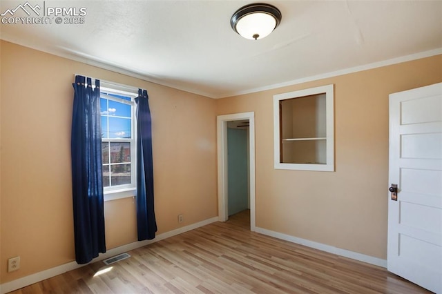 206 N 4th St, Victor, CO 80860 - spare room featuring light wood-style flooring, baseboards, and crown molding
