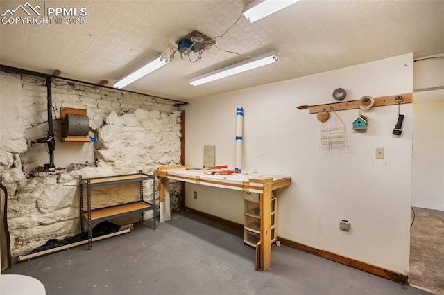 206 N 4th St, Victor, CO 80860 - below grade area featuring a workshop area and baseboards