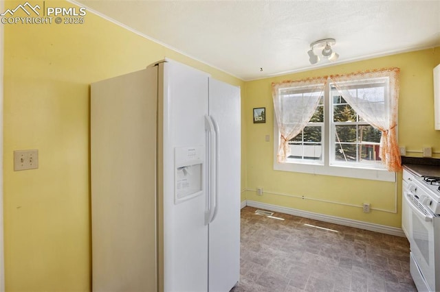 206 N 4th St, Victor, CO 80860 - kitchen featuring white appliances and baseboards