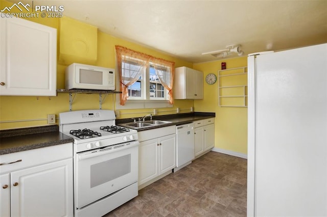206 N 4th St, Victor, CO 80860 - kitchen featuring white appliances, a sink, dark countertops, and white cabinetry