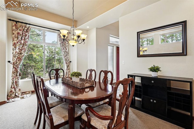 dining space with a chandelier, carpet floors, and recessed lighting