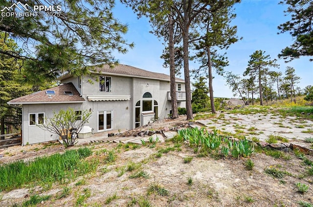 rear view of property with stucco siding
