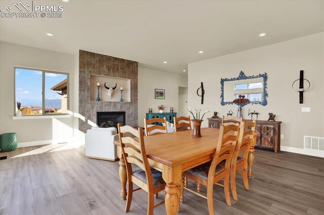 7871 Bannockburn Trl, Colorado Springs, CO 80908 - dining room featuring wood finished floors, baseboards, recessed lighting, and a tile fireplace