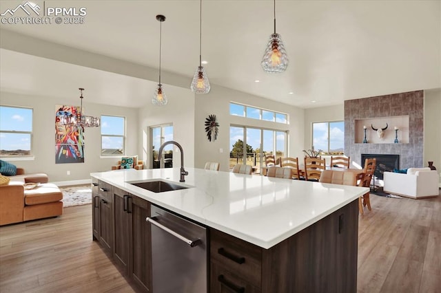 7871 Bannockburn Trl, Colorado Springs, CO 80908 - kitchen with a sink, open floor plan, stainless steel dishwasher, light wood-type flooring, and dark brown cabinetry
