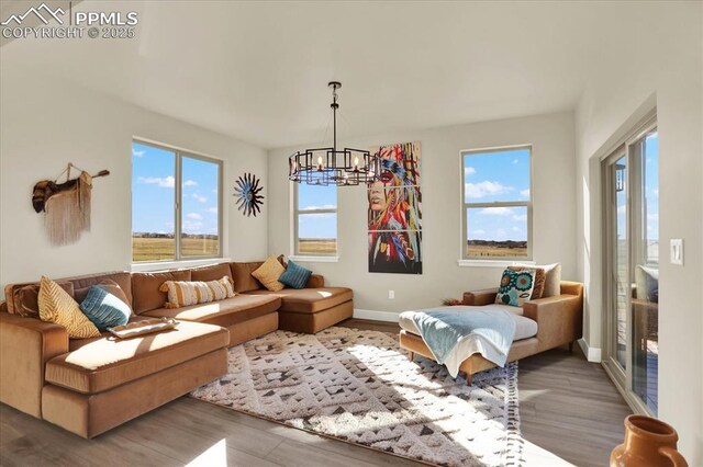 7871 Bannockburn Trl, Colorado Springs, CO 80908 - living room with a chandelier, wood finished floors, and baseboards
