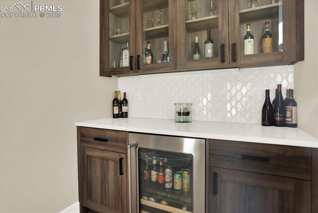 7871 Bannockburn Trl, Colorado Springs, CO 80908 - indoor dry bar featuring beverage cooler and decorative backsplash