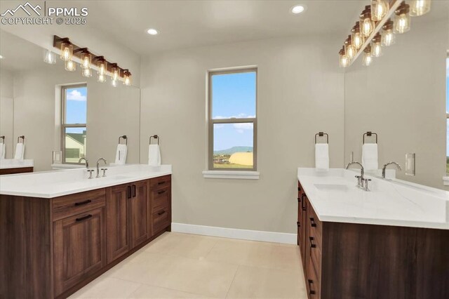 7871 Bannockburn Trl, Colorado Springs, CO 80908 - full bathroom with two vanities, plenty of natural light, baseboards, recessed lighting, and tile patterned floors