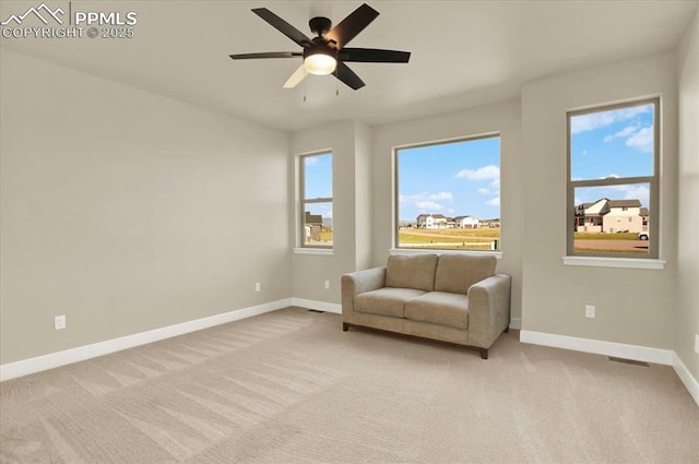 7871 Bannockburn Trl, Colorado Springs, CO 80908 - living area featuring baseboards, light carpet, and a ceiling fan