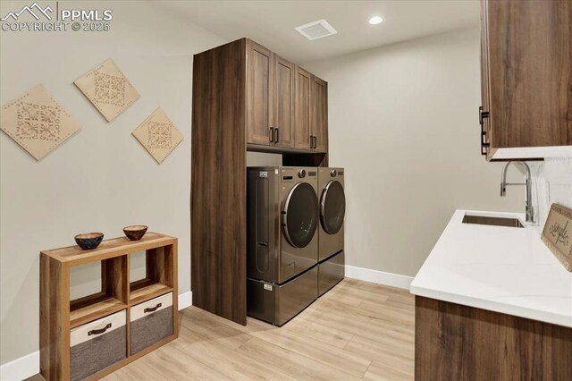 7871 Bannockburn Trl, Colorado Springs, CO 80908 - laundry room featuring cabinet space, independent washer and dryer, light wood-type flooring, baseboards, and recessed lighting