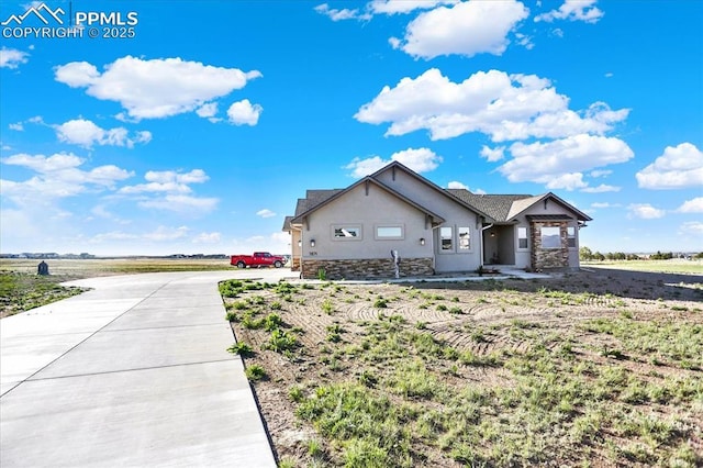 7871 Bannockburn Trl, Colorado Springs, CO 80908 - view of front facade with stone siding, stucco siding, and driveway
