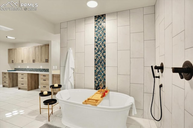 7871 Bannockburn Trl, Colorado Springs, CO 80908 - full bathroom with a freestanding tub, tile patterned floors, and tile walls