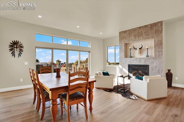 7871 Bannockburn Trl, Colorado Springs, CO 80908 - dining space featuring baseboards, light wood-type flooring, a fireplace, and recessed lighting