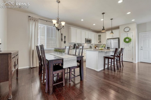 3793 Cadence Dr, Castle Rock, CO 80109 - dining room with dark wood finished floors, recessed lighting, and a chandelier