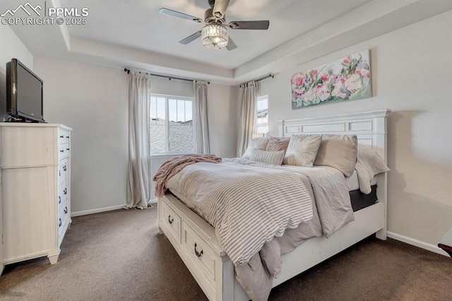 3793 Cadence Dr, Castle Rock, CO 80109 - bedroom featuring dark carpet, a raised ceiling, and a ceiling fan