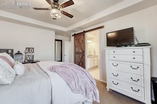 3793 Cadence Dr, Castle Rock, CO 80109 - bedroom with a barn door, light carpet, ensuite bath, ceiling fan, and a tray ceiling