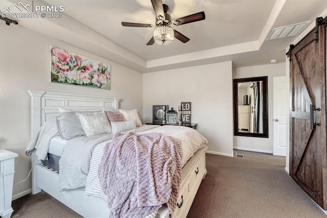 3793 Cadence Dr, Castle Rock, CO 80109 - bedroom with a barn door, dark colored carpet, a tray ceiling, and ceiling fan