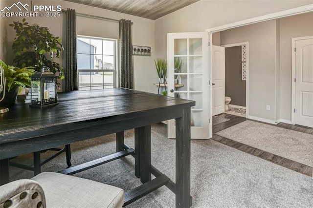 office area with baseboards, french doors, wood finished floors, and vaulted ceiling