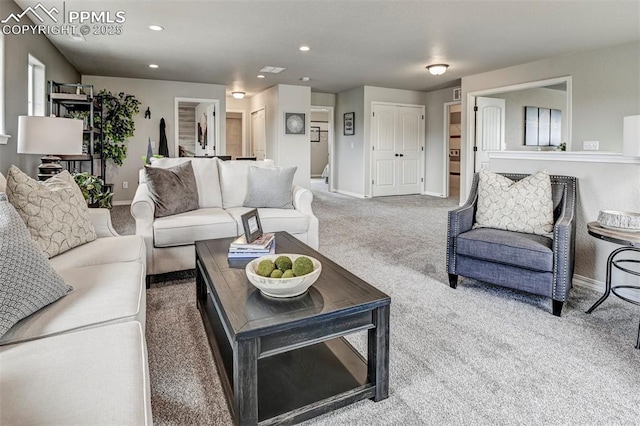 carpeted living area featuring baseboards and recessed lighting
