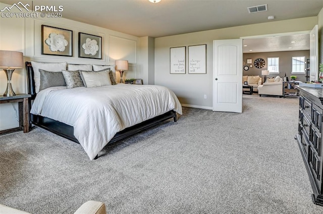 carpeted bedroom featuring baseboards