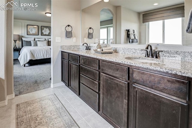 full bathroom with connected bathroom, plenty of natural light, double vanity, tile patterned floors, and recessed lighting