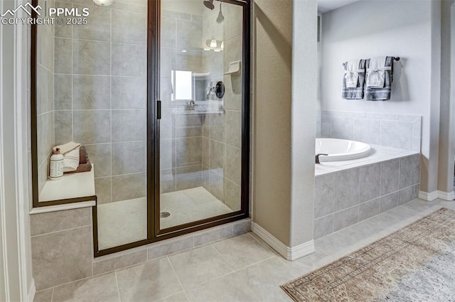 bathroom featuring tile patterned floors, a stall shower, and a bath