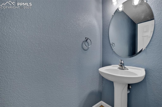 bathroom with a textured wall