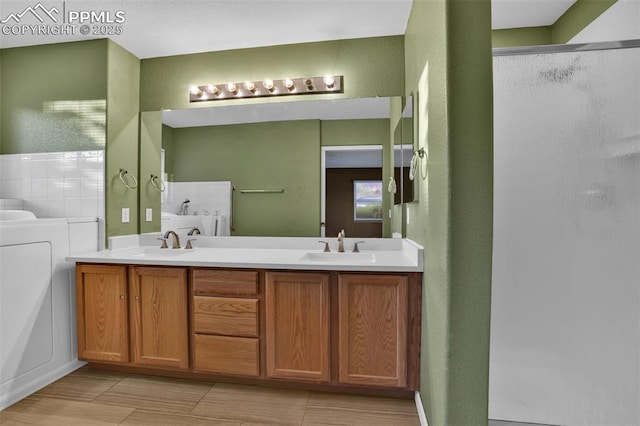 full bathroom featuring a stall shower, double vanity, and a bathtub