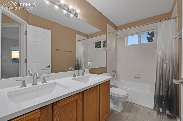 bathroom with toilet, shower / tub combo with curtain, and double vanity