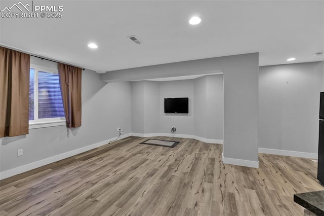 below grade area featuring wood finished floors, baseboards, and recessed lighting