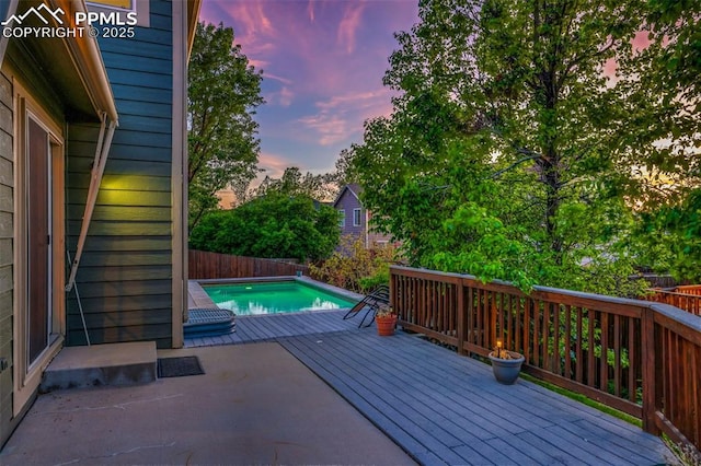wooden terrace featuring a fenced backyard