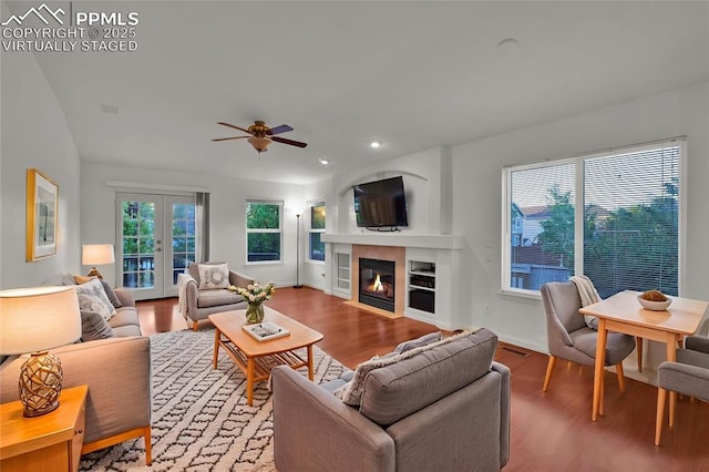 living room featuring wood finished floors, a ceiling fan, a fireplace, recessed lighting, and baseboards