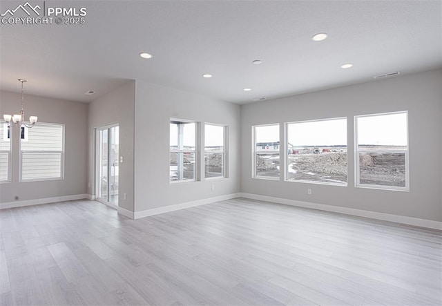 6045 Miller Run Pl, Colorado Springs, CO 80924 - unfurnished living room featuring a chandelier, healthy amount of natural light, recessed lighting, light wood-type flooring, and baseboards
