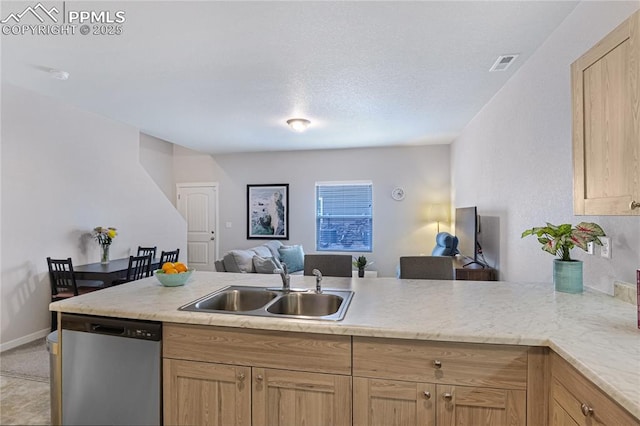 4082 Warthog Hts, Colorado Springs, CO 80916 - kitchen with dishwasher, open floor plan, a sink, light brown cabinetry, and a peninsula