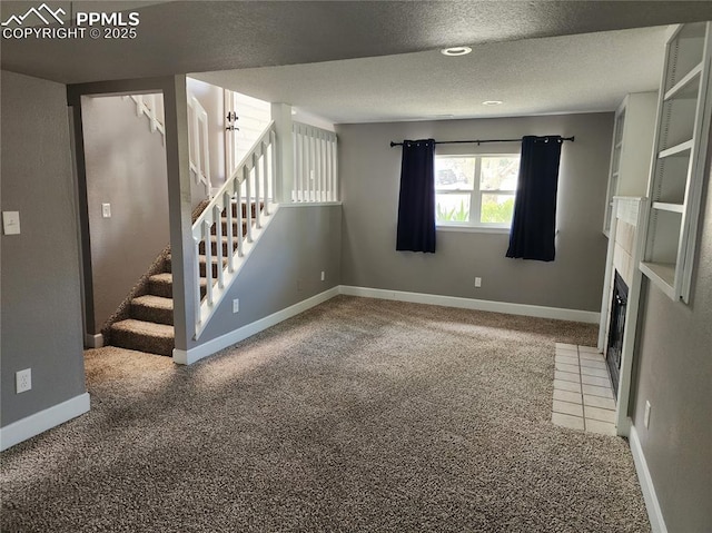 5427 Alteza Dr, Colorado Springs, CO 80917 - unfurnished living room with carpet floors, stairway, a textured ceiling, and baseboards