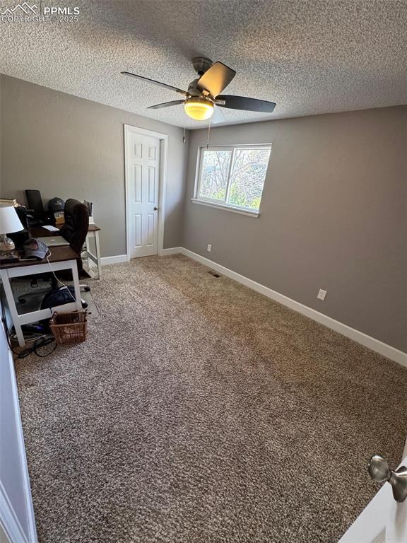 5427 Alteza Dr, Colorado Springs, CO 80917 - office area with ceiling fan, a textured ceiling, carpet floors, and baseboards