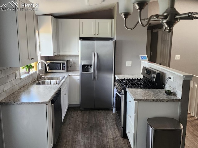 5427 Alteza Dr, Colorado Springs, CO 80917 - kitchen with appliances with stainless steel finishes, a sink, dark wood-type flooring, tasteful backsplash, and light countertops