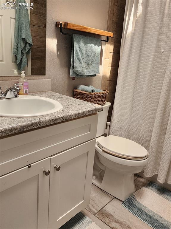 5427 Alteza Dr, Colorado Springs, CO 80917 - full bath featuring vanity, toilet, and a shower with curtain