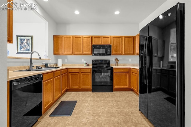 8147 Elk River Vw, Fountain, CO 80817 - kitchen with black appliances, a sink, light countertops, brown cabinetry, and recessed lighting
