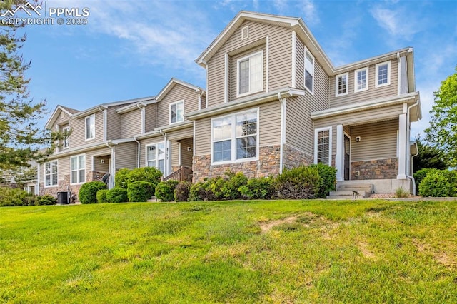 8147 Elk River Vw, Fountain, CO 80817 - view of front of home featuring stone siding, central AC, and a front yard