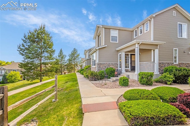 8147 Elk River Vw, Fountain, CO 80817 - view of side of property with stone siding, covered porch, and a yard