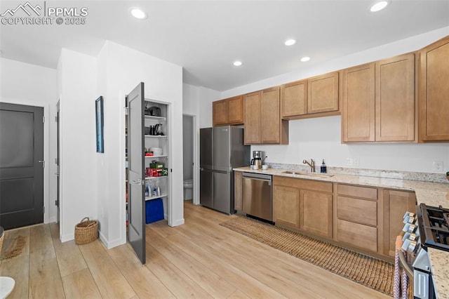 3565 Rosette Grv, Colorado Springs, CO 80910 - kitchen with stainless steel appliances, a sink, light wood-style floors, light stone counters, and recessed lighting